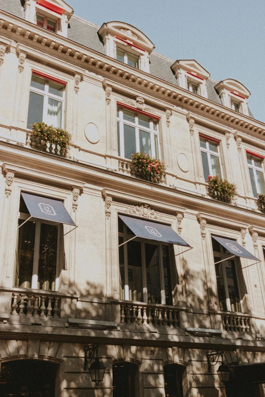 a large white building with many windows and balconies, unsplash, paris school, awnings, gourmet restaurant, architectural digest, blue