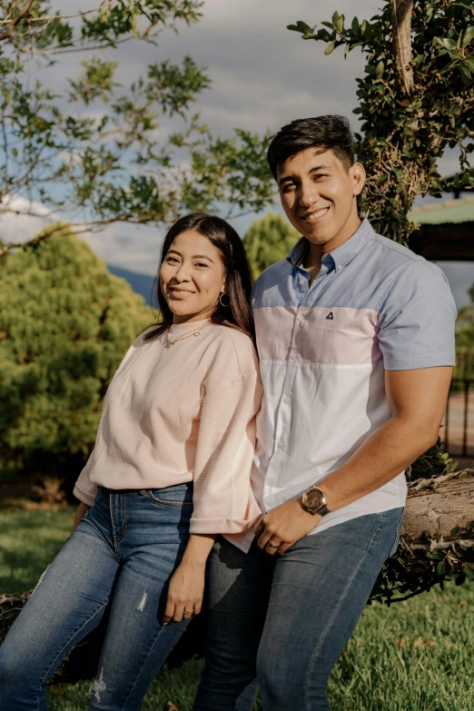 a man and a woman standing next to each other, by Robbie Trevino, wearing casual clothing, in a scenic background, college, pokimane