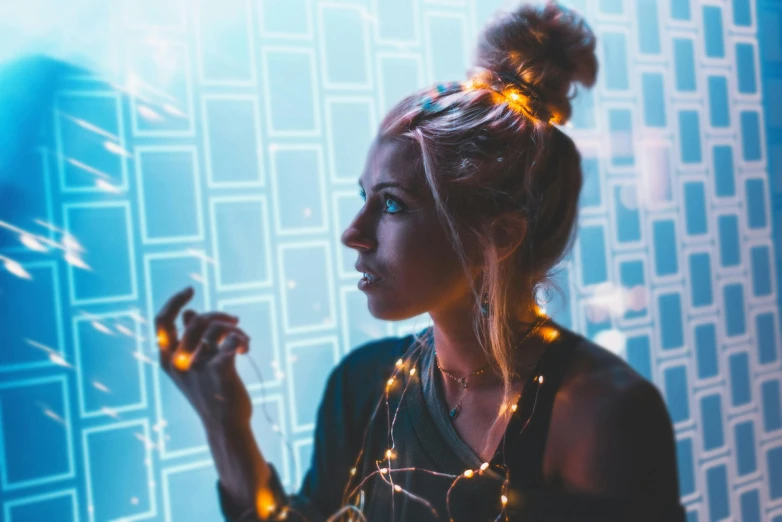 a woman standing in front of a wall with lights, a portrait, pexels contest winner, cyberpunk ornaments, girl with messy bun hairstyle, a blond, portrait featured on unsplash