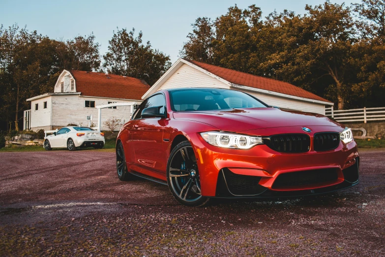 a red car parked in front of a white house, pexels contest winner, bmw, avatar image, brown, on a street race track