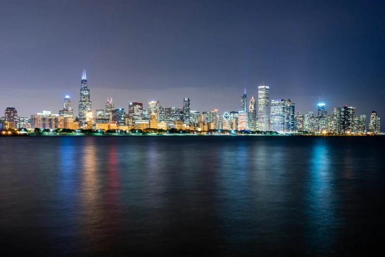 a large body of water with a city in the background, by Greg Rutkowski, pexels contest winner, vibrant lights, from wheaton illinois, group photo, high resolution photo