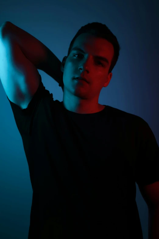 a man in a black shirt holding a baseball bat, an album cover, inspired by Carlo Mense, pexels contest winner, bisexual lighting, he is wearing a black t-shirt, blue light, julian ope