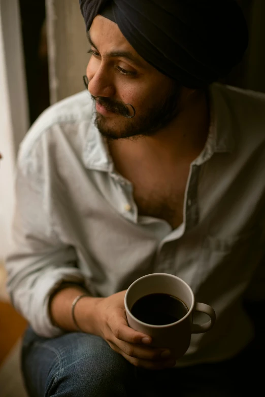 a man in a turban holding a cup of coffee, trending on pexels, with a seductive smile, avatar image, alessio albi, natural mustache