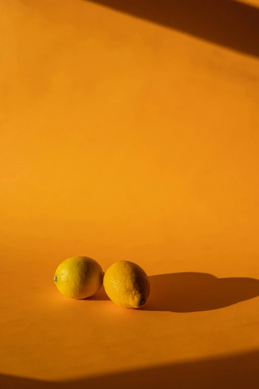 a couple of lemons sitting on top of a table, an album cover, by Andries Stock, unsplash contest winner, orange subsurface scattering, 15081959 21121991 01012000 4k, volumetric light and shadow, 🐿🍸🍋