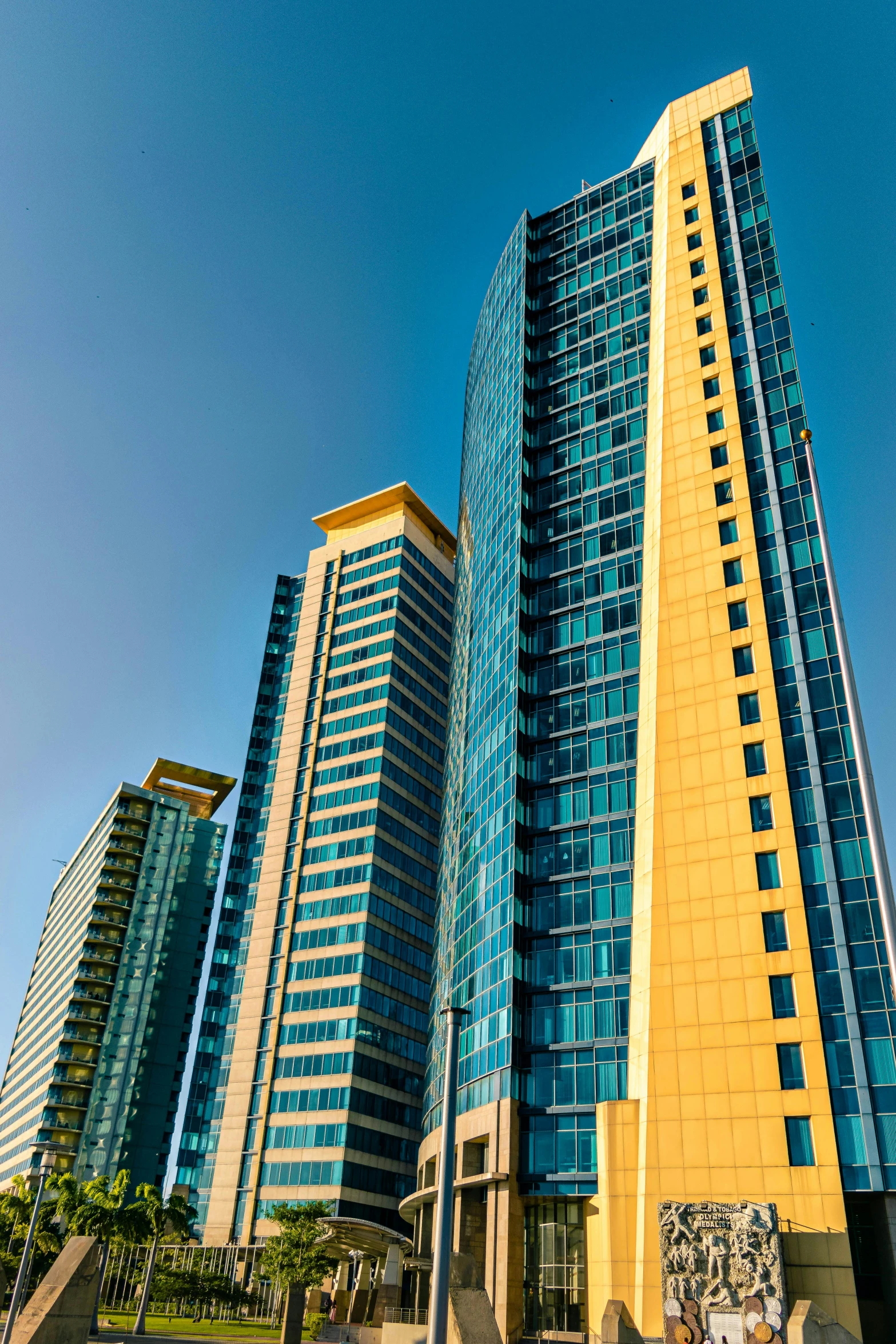 a group of tall buildings sitting next to each other, by Doug Ohlson, slide show, yellow and blue, manila, apartments