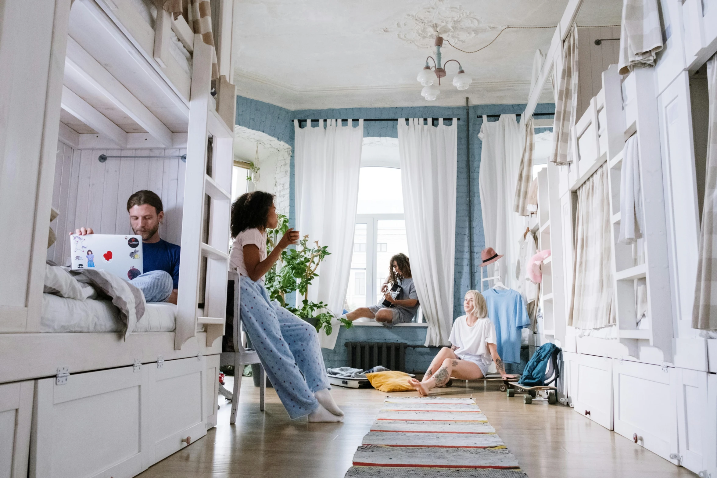 a group of people in a room with bunk beds, pexels contest winner, midsommar, blue room, premium quality, profile image