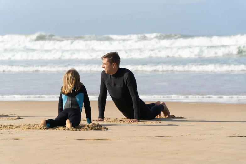 a man and a little girl sitting on the beach, surfing, graeme base, no crop, leaking