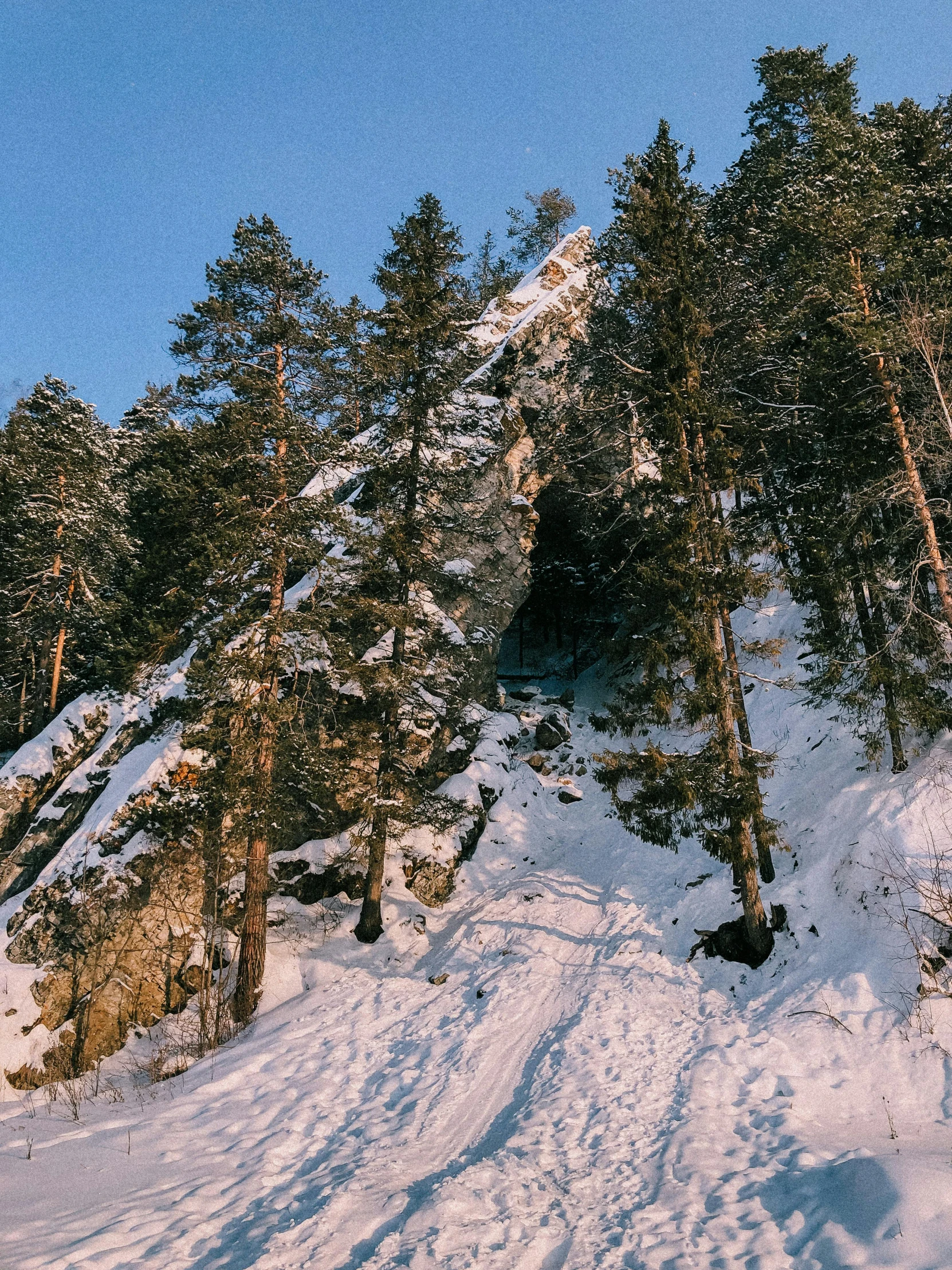 a man riding a snowboard down a snow covered slope, trees and cliffs, baba yaga, instagram post, thumbnail