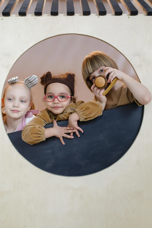 a group of children standing next to each other, an album cover, inspired by Louis Le Nain, trending on pexels, photorealism, portholes, wood print, 9 0 mm studio photograph tiny, softplay