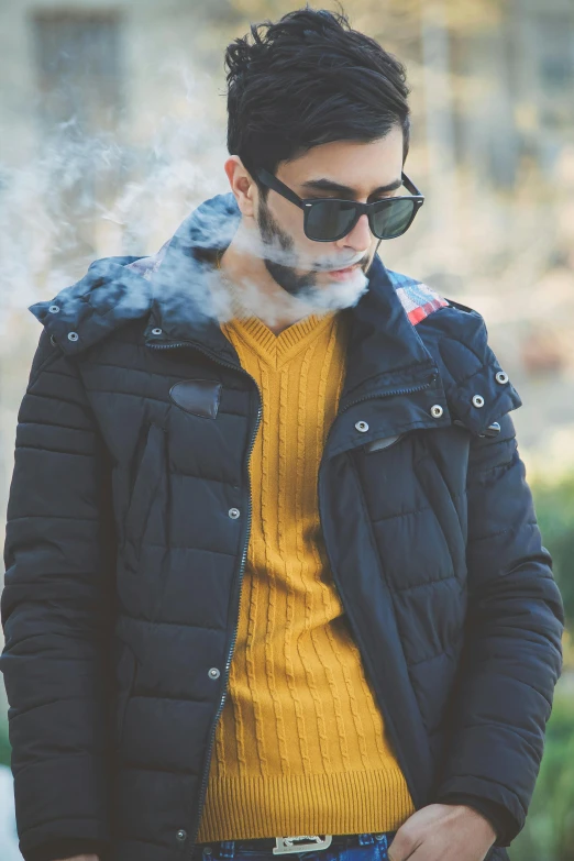 a man in a yellow sweater smokes a cigarette, trending on pexels, model wears a puffer jacket, tehran, thc, wearing shades