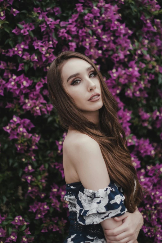 a woman standing in front of purple flowers, by Robbie Trevino, lilly collins, avatar image, low quality photo, pokimane