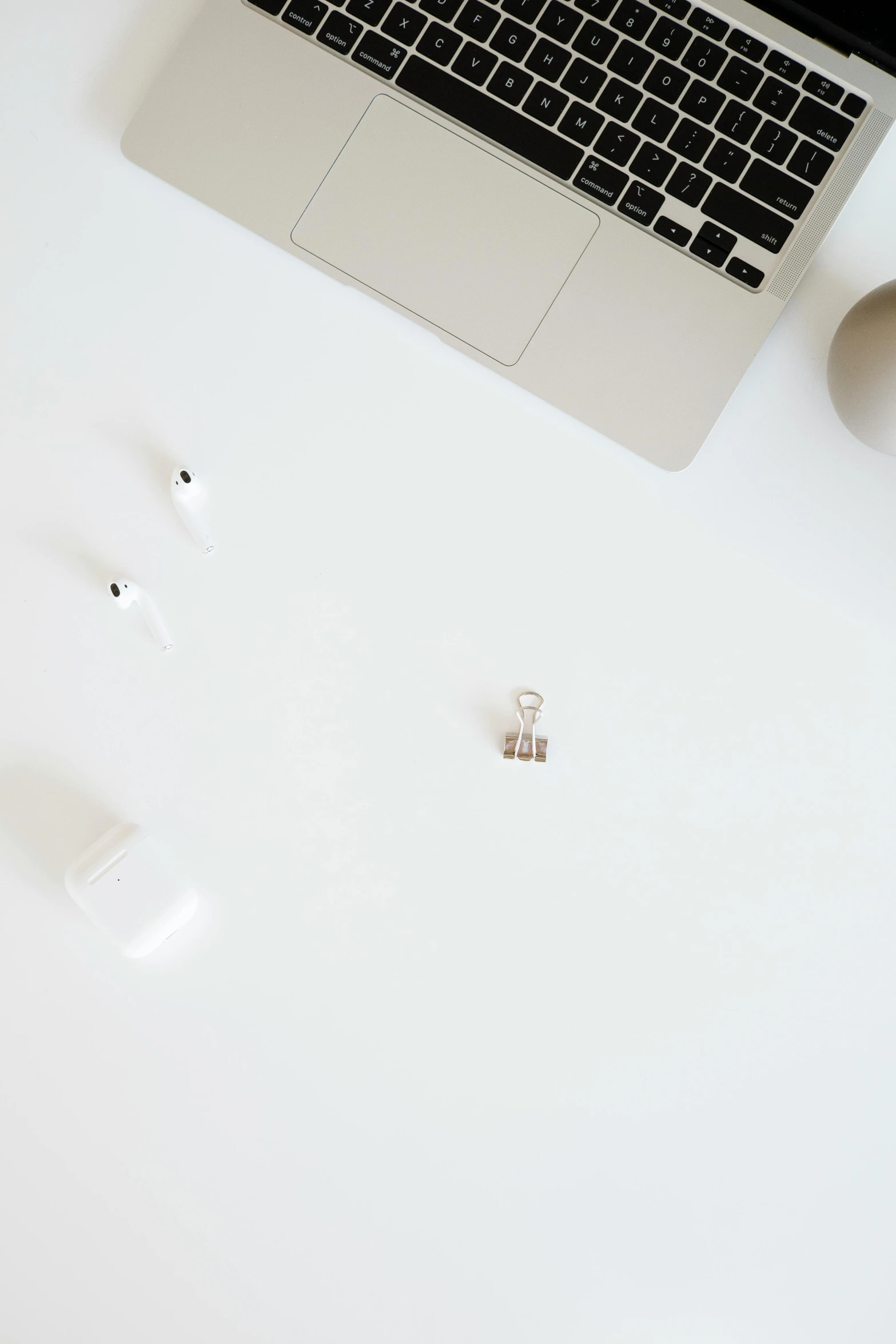 a laptop computer sitting on top of a white table, by Andries Stock, trending on unsplash, minimalism, bling earbuds, mini figure, vanilla, low quality photo