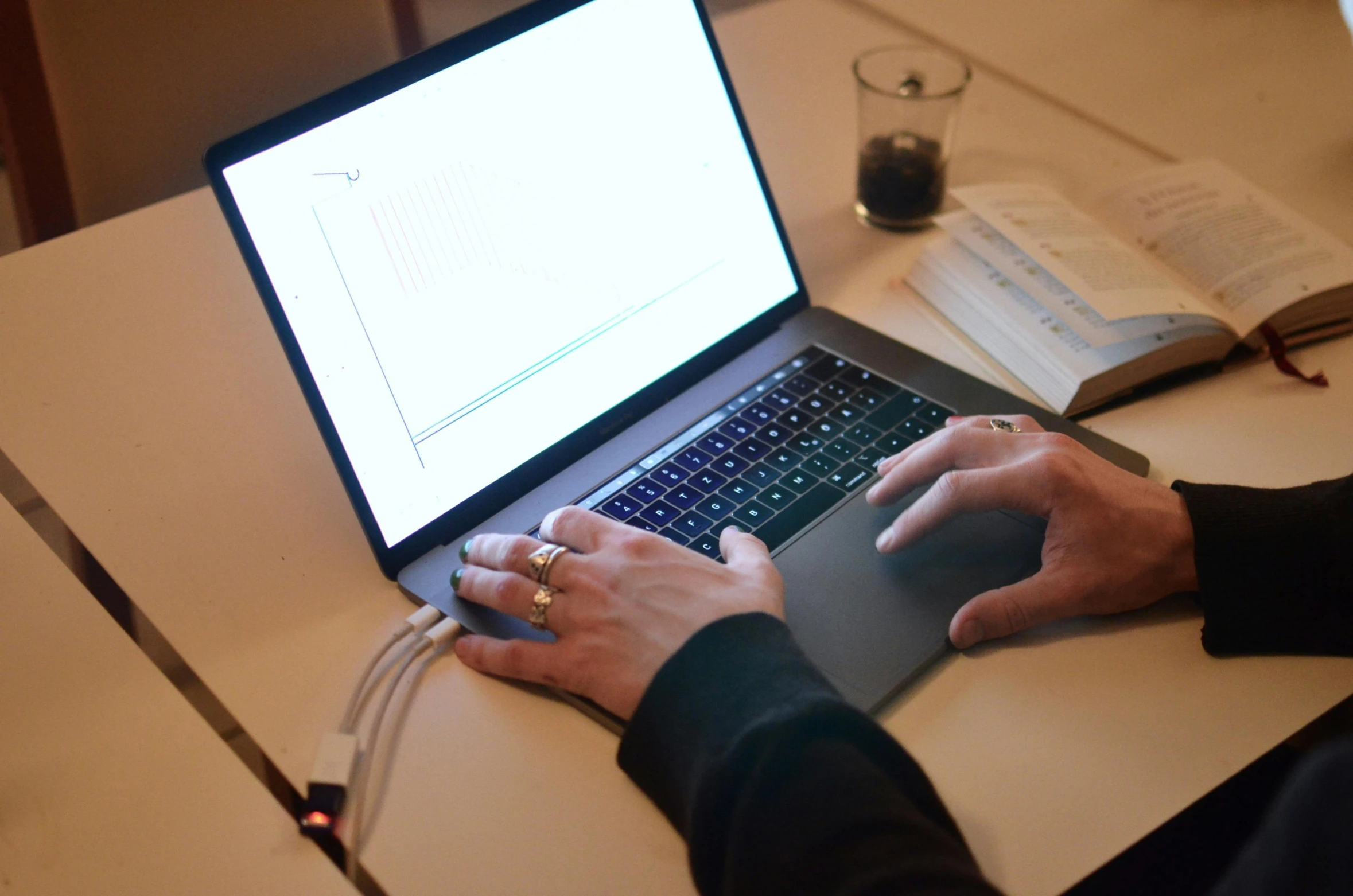 a person sitting at a desk using a laptop computer, by Carey Morris, data bending, readable, ignant, teaching