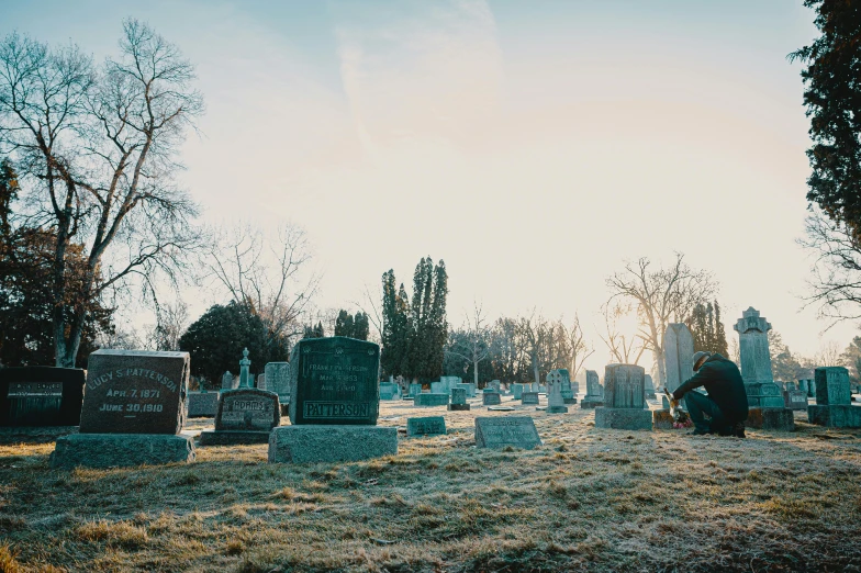 a cemetery with tombstones and trees in the background, an album cover, unsplash, ultrawide cinematic, dead bodies, morning light, ignant