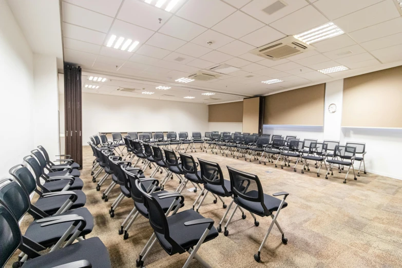 a conference room with rows of chairs and a projector screen, danube school, square, high-quality photo, fan favorite, monika