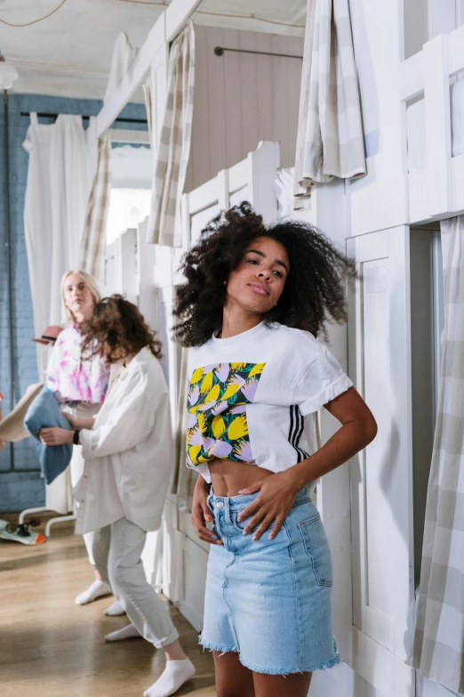 a group of women standing next to each other in a room, trending on unsplash, happening, wearing adidas clothing, curly haired, photograph of three ravers, dressed in a white t-shirt