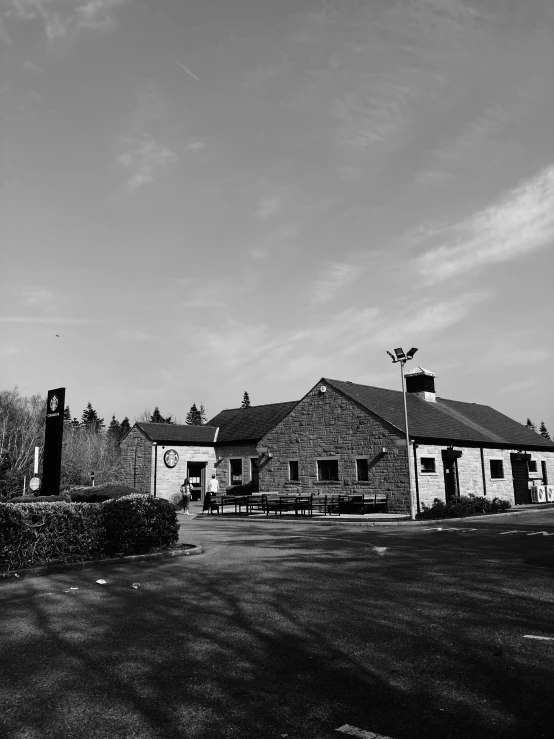 a black and white photo of a building, a black and white photo, by Jan Gregoor, unsplash, barbizon school, small town surrounding, gas station, ilustration, low quality photo