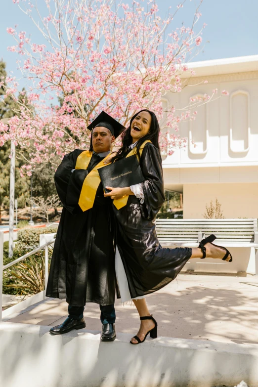 a couple of women standing next to each other, unsplash, renaissance, graduation photo, triumphant pose, man and woman, alanis guillen