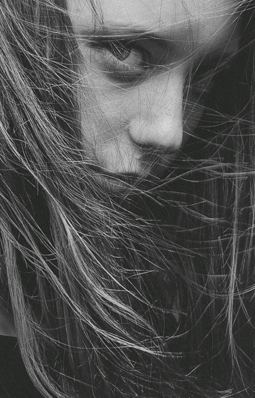 a black and white photo of a woman with long hair, pexels contest winner, realism, windy mane, close face view, scratches, vsco film grain