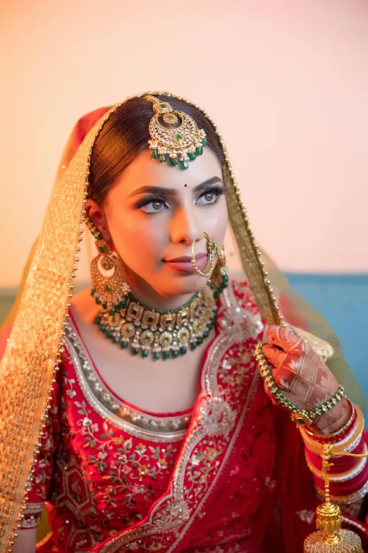 a woman dressed in a red and gold outfit, a portrait, inspired by Ambreen Butt, trending on pexels, red green, wedding, square, an attractive