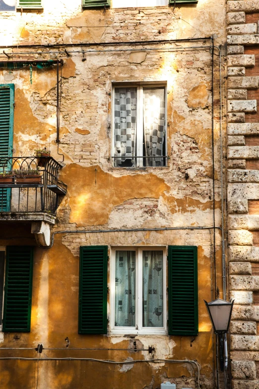 a building with green shutters on a sunny day, inspired by Carlo Maderna, renaissance, rust and plaster materials, exterior, warm glow, square