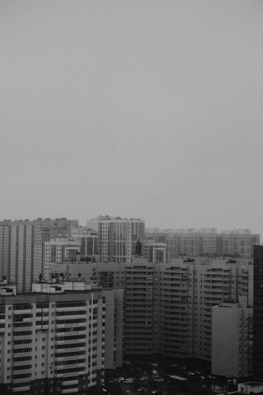 a black and white photo of a city, inspired by Zhang Kechun, unsplash, moscow, low quality footage, overcast, residential area