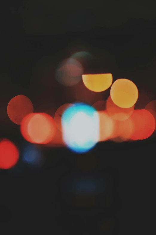 a blurry photo of a city at night, unsplash, overcast bokeh - c 5, colorful”