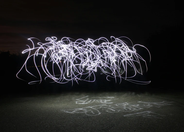 a light painting on the ground in the dark, a stipple, inspired by Bruce Munro, unsplash, graffiti, angry light, white sketch lines, swirling scene, taken with canon 5d mk4