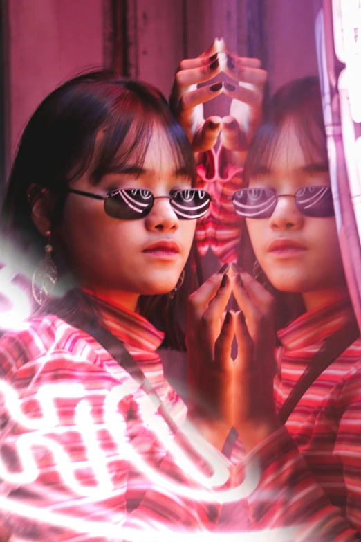 a couple of young girls standing next to each other, an album cover, inspired by Bernardino Mei, trending on pexels, mirror shades, asian girl, left eye red stripe, trippy mood