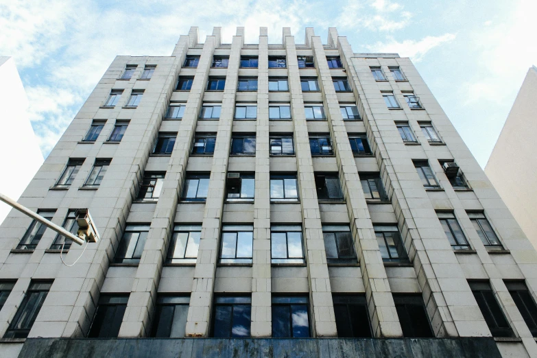 a very tall building with lots of windows, by Arthur Sarkissian, unsplash, brutalism, neoclassical police station, zezhou chen, 2000s photo, uhq