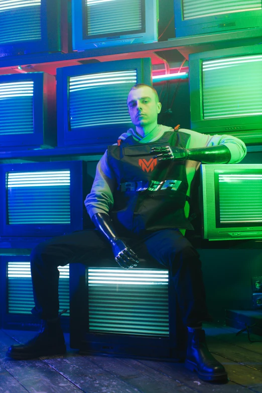 a man sitting on a bench in front of a wall of televisions, an album cover, inspired by Kuno Veeber, holography, wearing space techwear, buzz cut, model is wearing techtical vest, 2019 trending photo