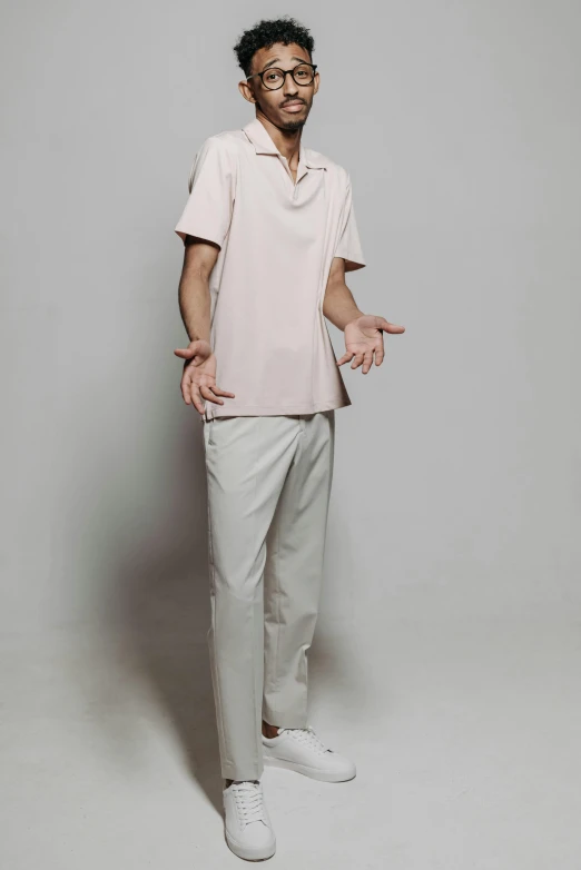 a man standing with his hands in his pockets, an album cover, inspired by Chen Chun, white and light-pink outfit, wearing polo shirt, - 12p, beige