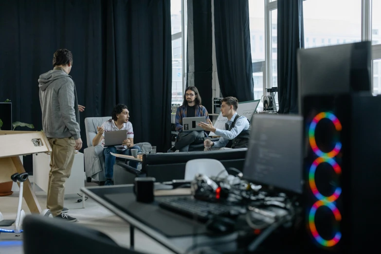 a group of people sitting around a table in a room, a computer rendering, adafruit, color grading, performance, lounge