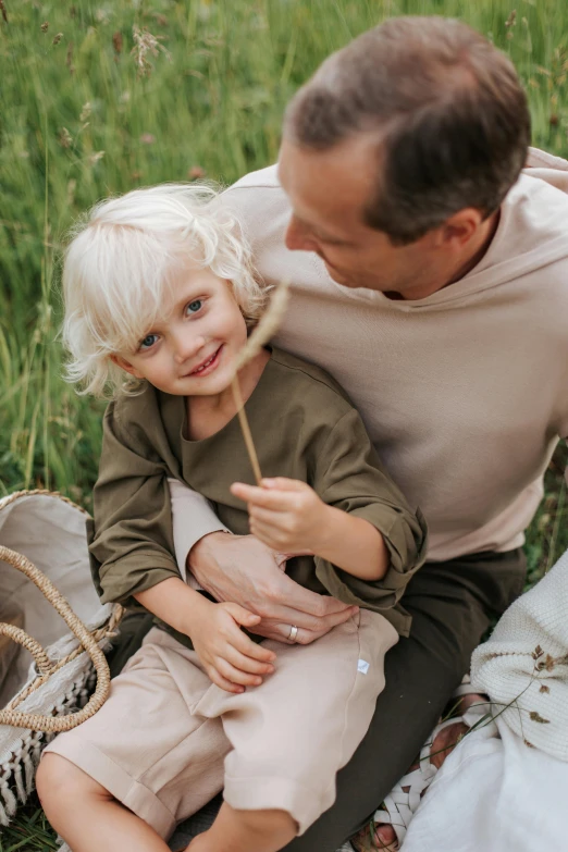 a man and a little girl sitting on a blanket, pexels contest winner, blond boy, organic detail, having a picnic, natural muted tones