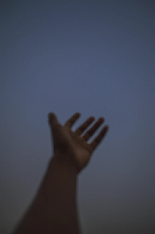 a person's hand reaching up into the sky, by Attila Meszlenyi, humid evening, photograph”