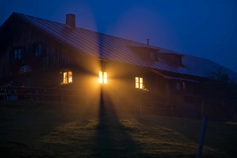 a long shadow of a person standing in front of a barn, by Sebastian Spreng, pexels contest winner, magical realism, cabin lights, predawn, light reflecting off windows, howl\'s moving castle at night