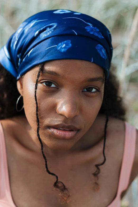 a close up of a person wearing a headscarf, renaissance, sza, movie still of a tired, young southern woman, two blue braids