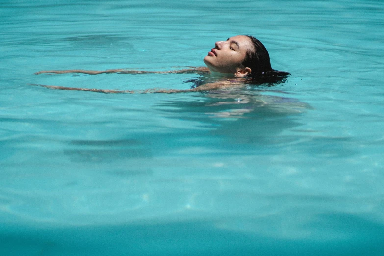 a woman floating in a pool with a frisbee, inspired by Elsa Bleda, pexels contest winner, phoebe tonkin, reflective skin, subtle detailing, no words 4 k