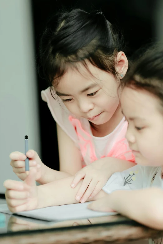 two little girls sitting at a table writing, a child's drawing, by Reuben Tam, pexels contest winner, arm around her neck, grey, 15081959 21121991 01012000 4k, xiang duan