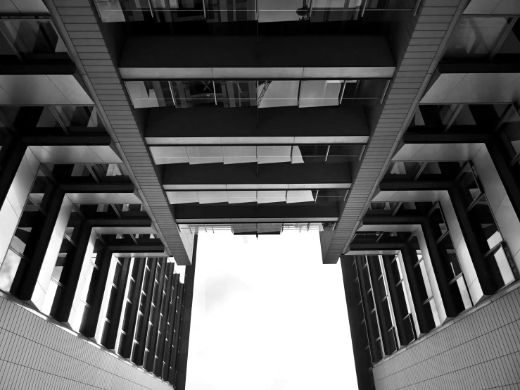 a black and white photo of a tall building, a black and white photo, unsplash, brutalism, underside, sky bridge, high details photo