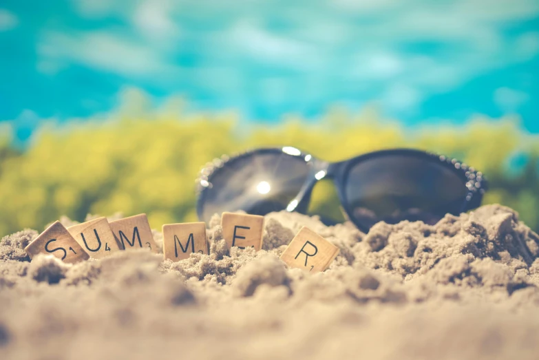 a pair of sunglasses sitting on top of a sandy beach, a picture, midsummer, summer street, skincare, august