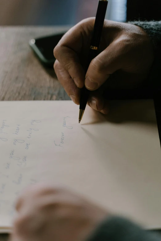 a person writing on a piece of paper with a pen, on old paper, ignant, thumbnail, uncropped