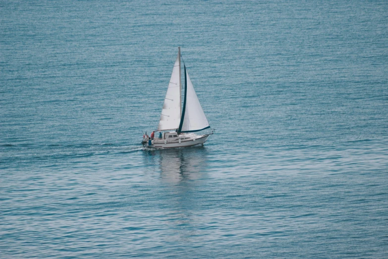 a sailboat in the middle of a large body of water, inspired by Alfred Wallis, pexels contest winner, hurufiyya, picton blue, shot on 1 5 0 mm, oceanside, family friendly