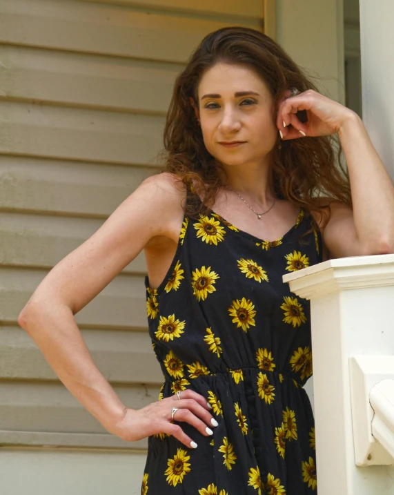 a woman standing next to a white fire hydrant, a portrait, by Lisa Milroy, colors : yellow sunflowers, wearing black camisole outfit, with a front porch, 90s photo