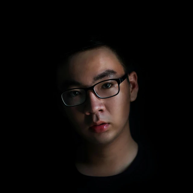 a close up of a person wearing glasses, by Shang Xi, black backdrop, andrew thomas huang, ((portrait)), intimidating glare