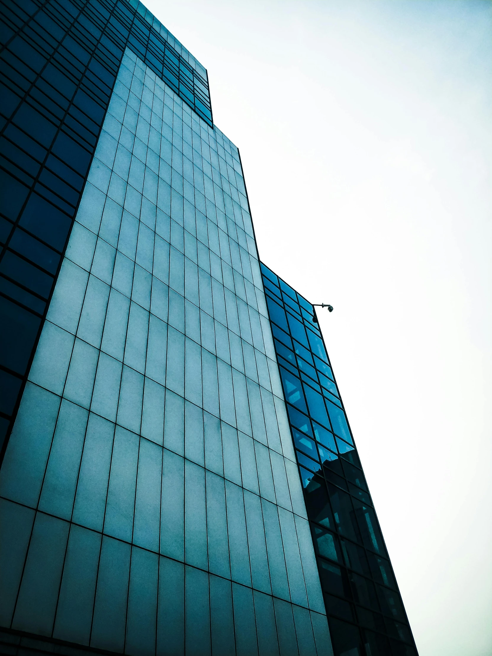 a tall building with a street light in front of it, by Adam Marczyński, glass wall, high quality image, multiple stories, commercial banner