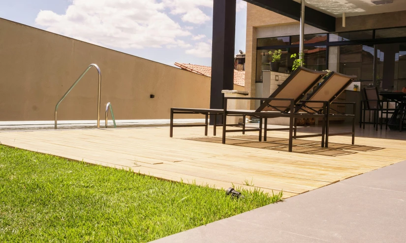 a couple of lounge chairs sitting on top of a wooden deck, by Alejandro Obregón, unsplash, realism, turf roof, in sao paulo, profile image, sunny day time