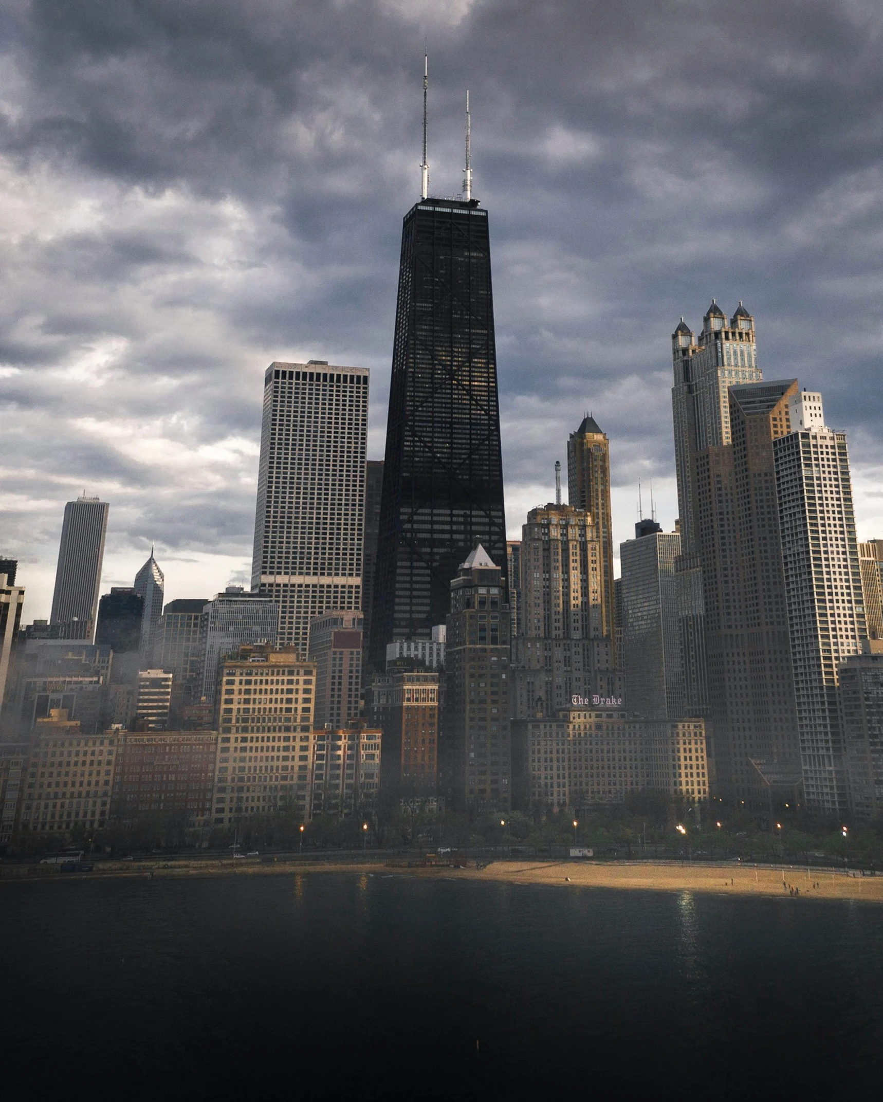 a view of a city on a cloudy day, by Andrew Domachowski, pexels contest winner, judy chicago, lgbtq, shoreline, realistic photo