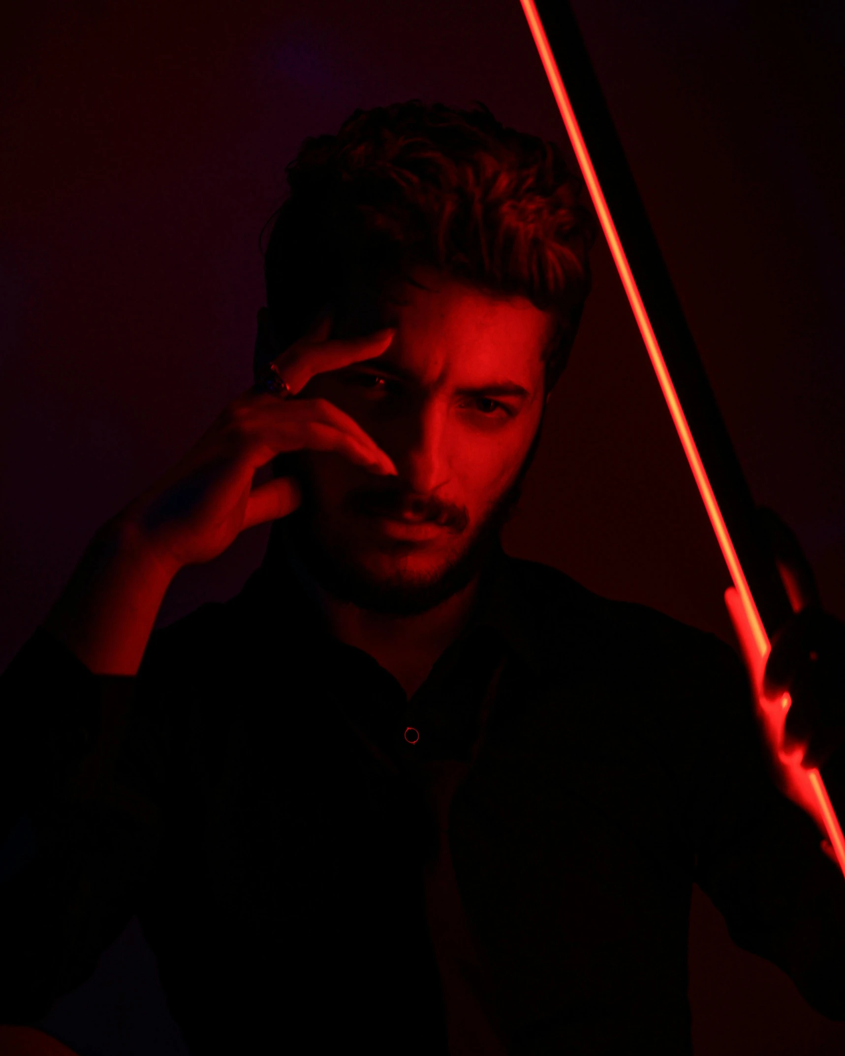 a man talking on a cell phone while holding a violin, an album cover, by Cosmo Alexander, trending on pexels, romanticism, red led eyes, reza afshar, with bow and arrow, male model