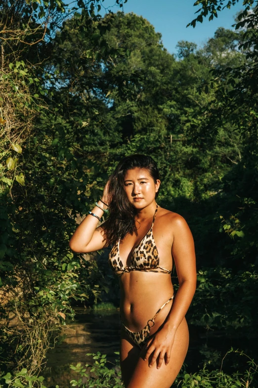 a woman in a leopard print bikini posing for a picture, by Andrée Ruellan, unsplash, sumatraism, full bodied portrait, slightly pixelated, portrait of christy ren, in her early 3 0